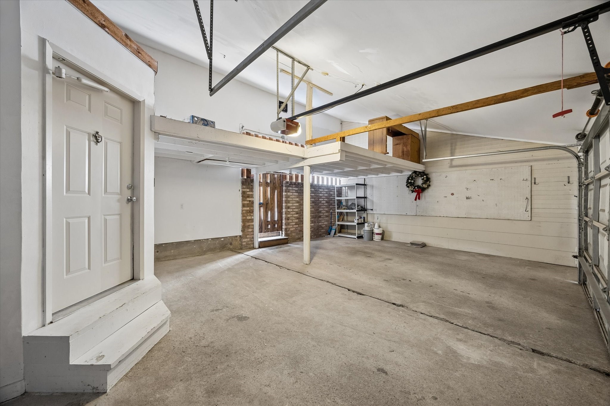 727 Bunker Hill Road, Unit 92 Houston, TX 77024 - Photo 37 of 50 GARAGE WALL WITH FUNCTIONAL HANGING RACK.