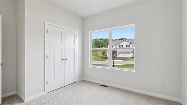 an empty room with windows and closet