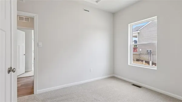an empty room with windows and closet