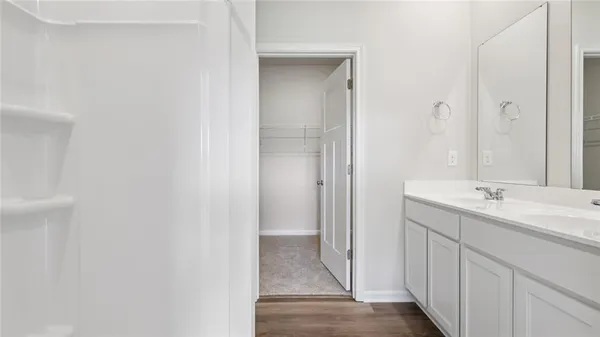 a bathroom with a double vanity sink and mirror