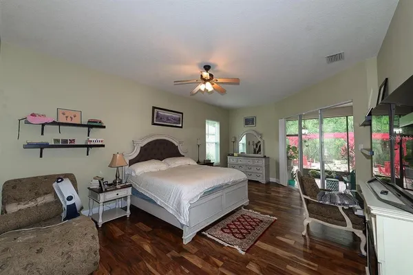 a living room with furniture a rug and a flat screen tv
