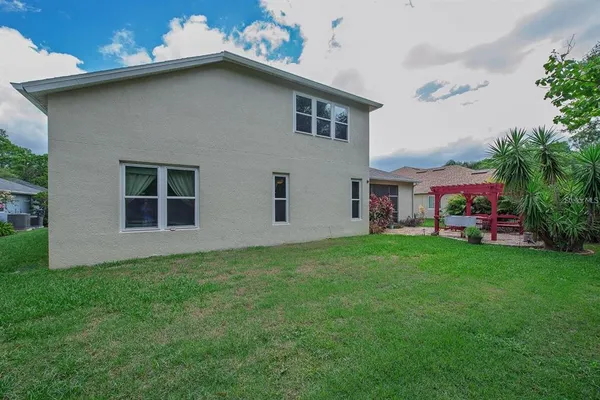 a view of house with backyard space and garden