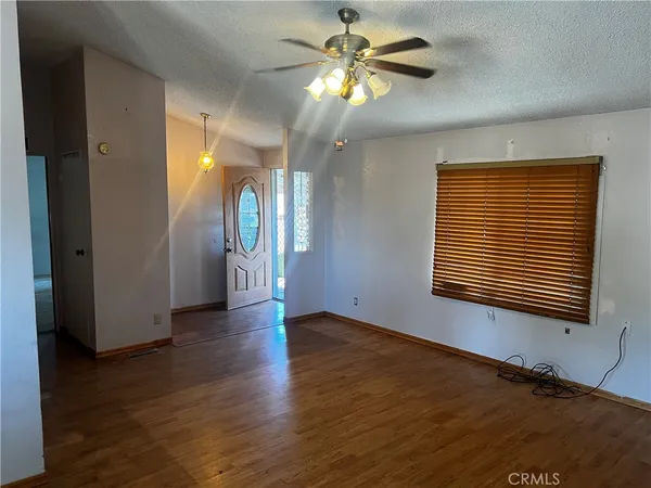 a kitchen with granite countertop white cabinets and wooden floor