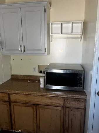 a kitchen with a refrigerator and cabinets