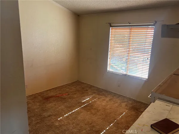a bathroom with a granite countertop sink and washing machine