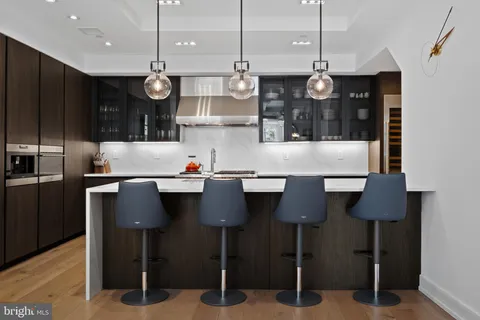 a kitchen with stainless steel appliances granite countertop a sink a refrigerator and a stove