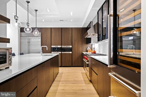 a kitchen with stainless steel appliances granite countertop a sink and a refrigerator