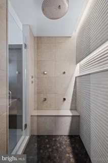 a bathroom with a bathtub and shower