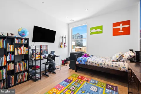 a bedroom with bed and a bookshelf