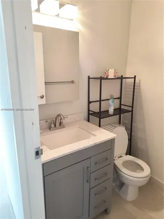 a bathroom with a toilet a sink and a mirror