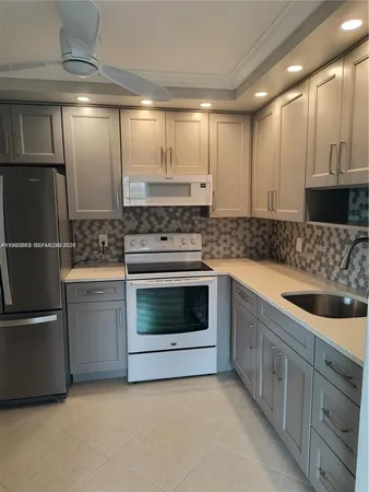 a kitchen with stainless steel appliances granite countertop a stove and a refrigerator