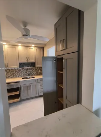 a kitchen with stainless steel appliances a refrigerator and cabinets