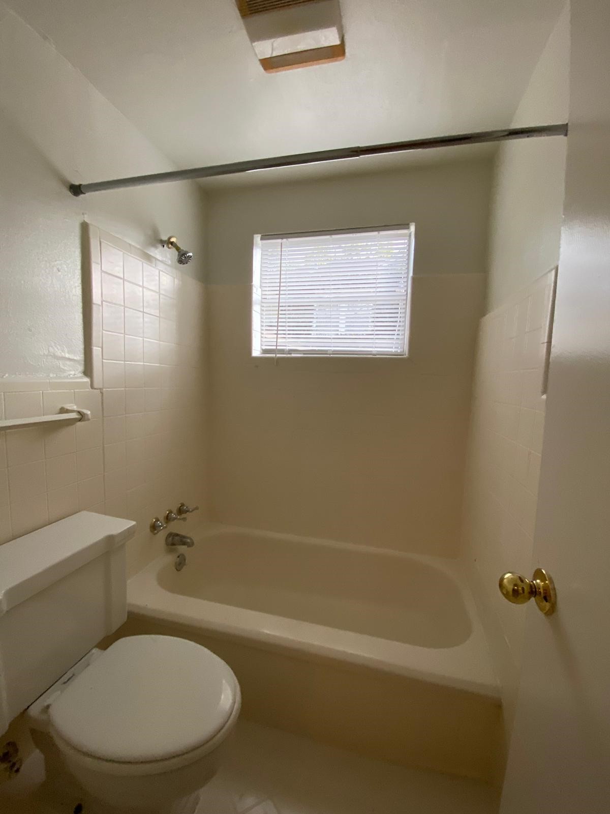 1909 Colquitt Street, Unit 3 Houston, TX 77098 - Photo 15 of 16 a white toilet sitting next to a bath tub and a shower