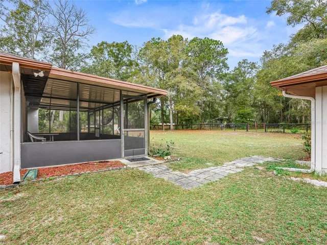a view of a backyard with a garden and trees