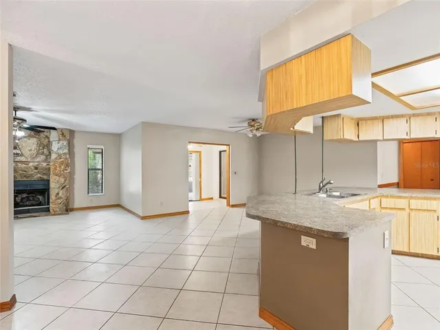 a view of a kitchen with a sink and a window