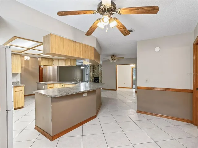 a kitchen with granite countertop a sink and a stove top oven