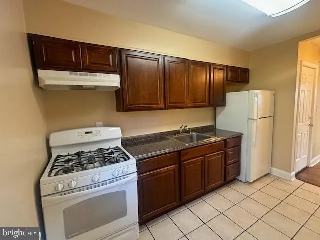 a kitchen with a stove cabinets and refrigerator