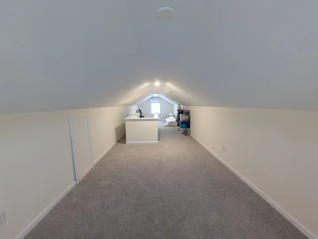 a view of empty room with a fireplace