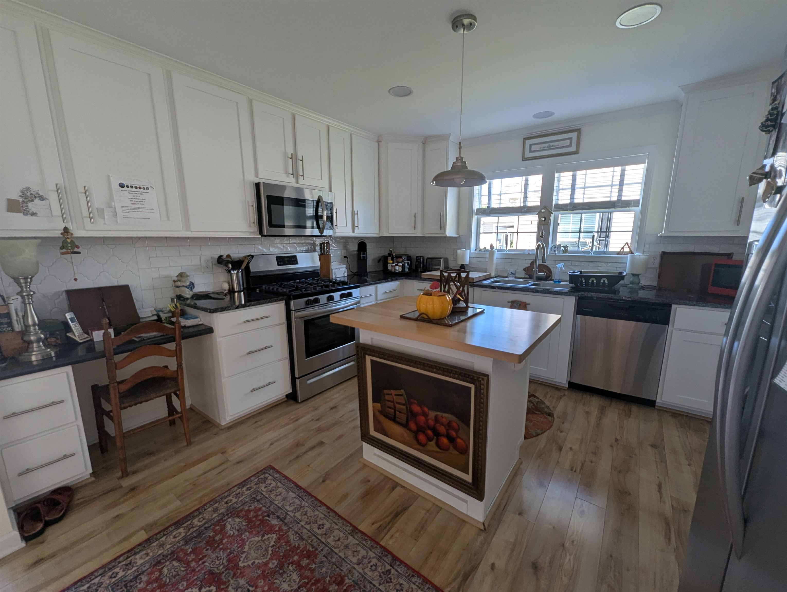 2058 Shore Ocean View, NJ 08230 - Photo 7 of 28 a living room with stainless steel appliances a stove a sink a refrigerator cabinets and a center island