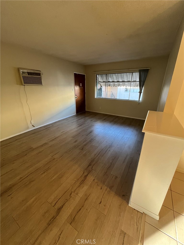 14632 Erwin Street, Unit 7 Van Nuys, CA 91411 - Photo 3 of 11 a view of empty room with wooden floor and fan