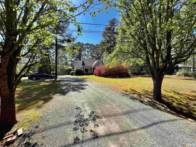 a view of yard with tree in front of it