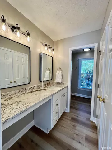 a bathroom with double vanity sinks and a vanity