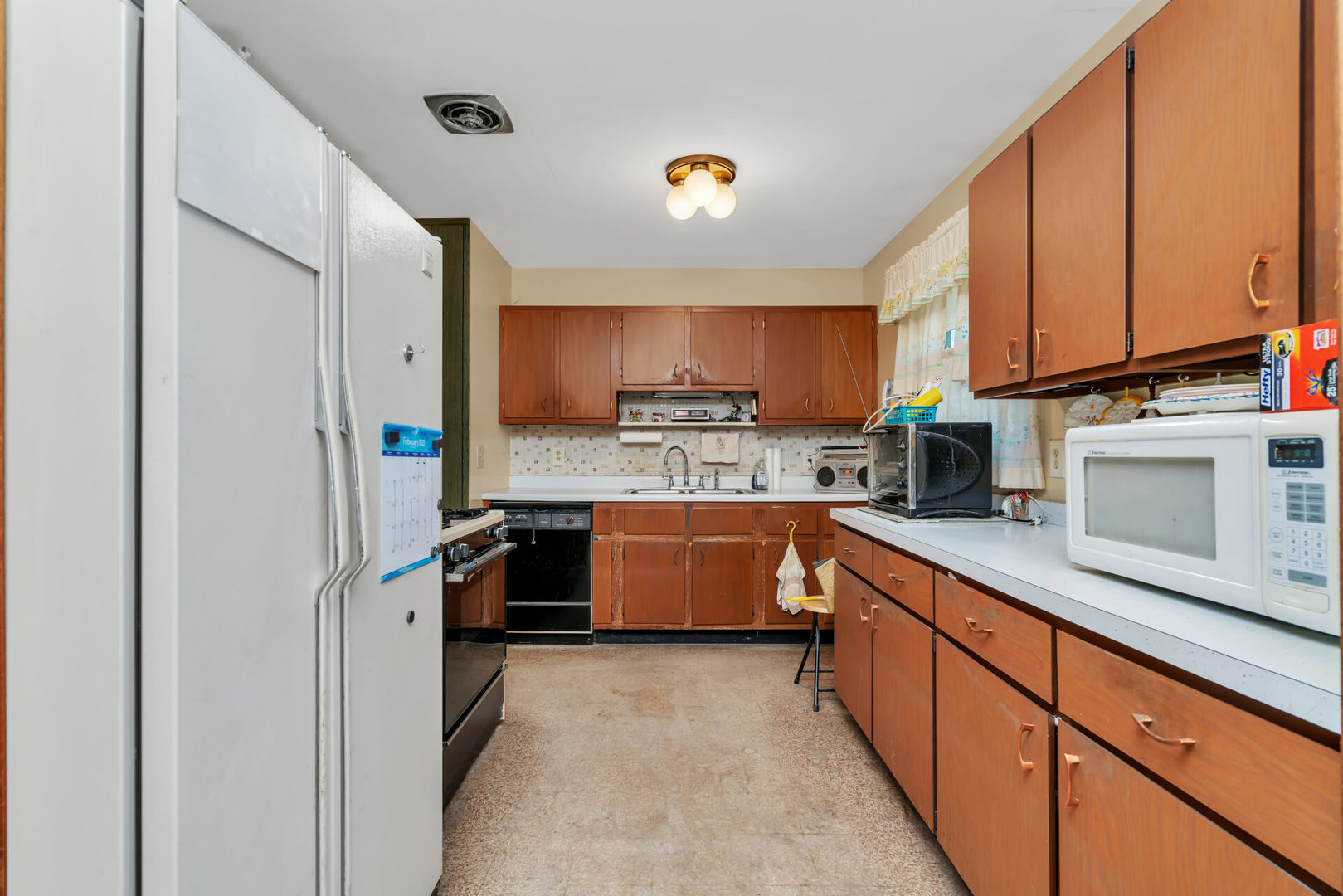 96 South Street Cary, IL 60013 - Photo 9 of 14 a kitchen with stainless steel appliances a refrigerator sink and cabinets