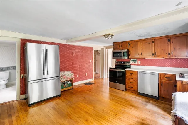 a kitchen with stainless steel appliances granite countertop a refrigerator oven a stove top oven a sink and dishwasher