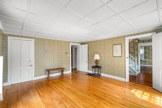 a view of a livingroom with furniture and an empty room