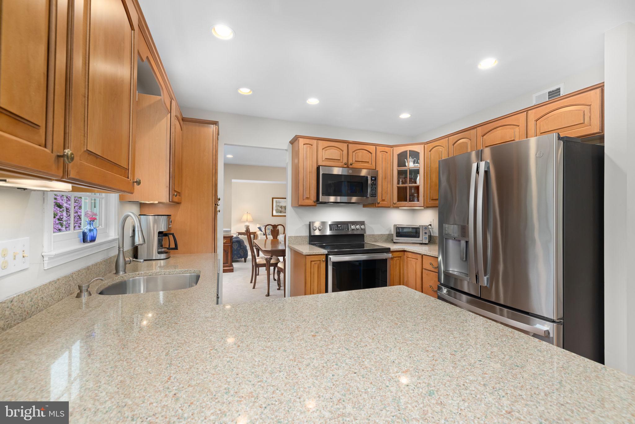 6964 Conservation Drive Springfield, VA 22153 - Photo 11 of 57 a kitchen with stainless steel appliances granite countertop a refrigerator sink and stove