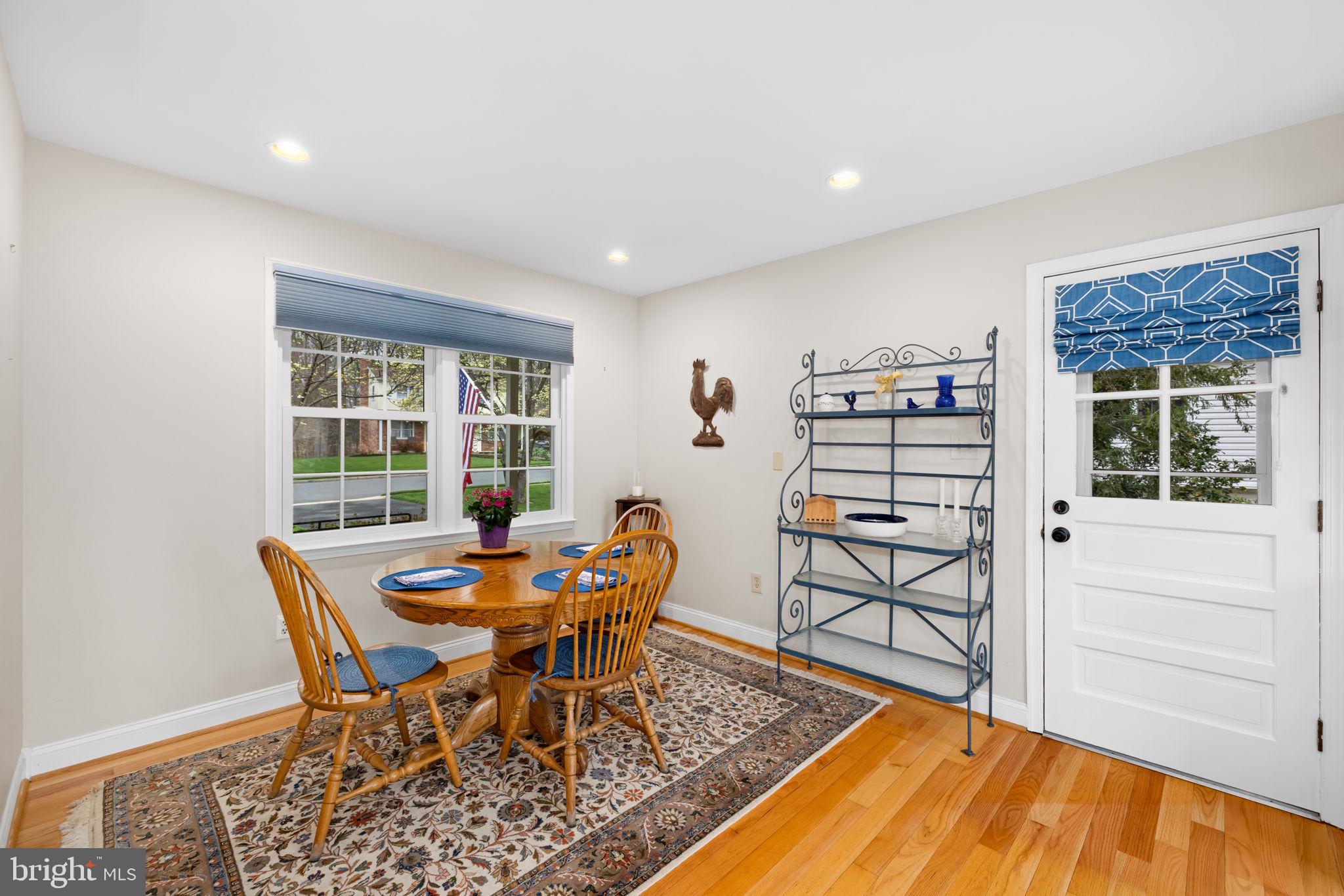 6964 Conservation Drive Springfield, VA 22153 - Photo 13 of 57 a dining room with furniture and wooden floor