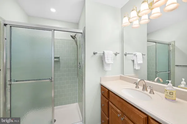 a bathroom with a toilet a sink a mirror and a bathtub