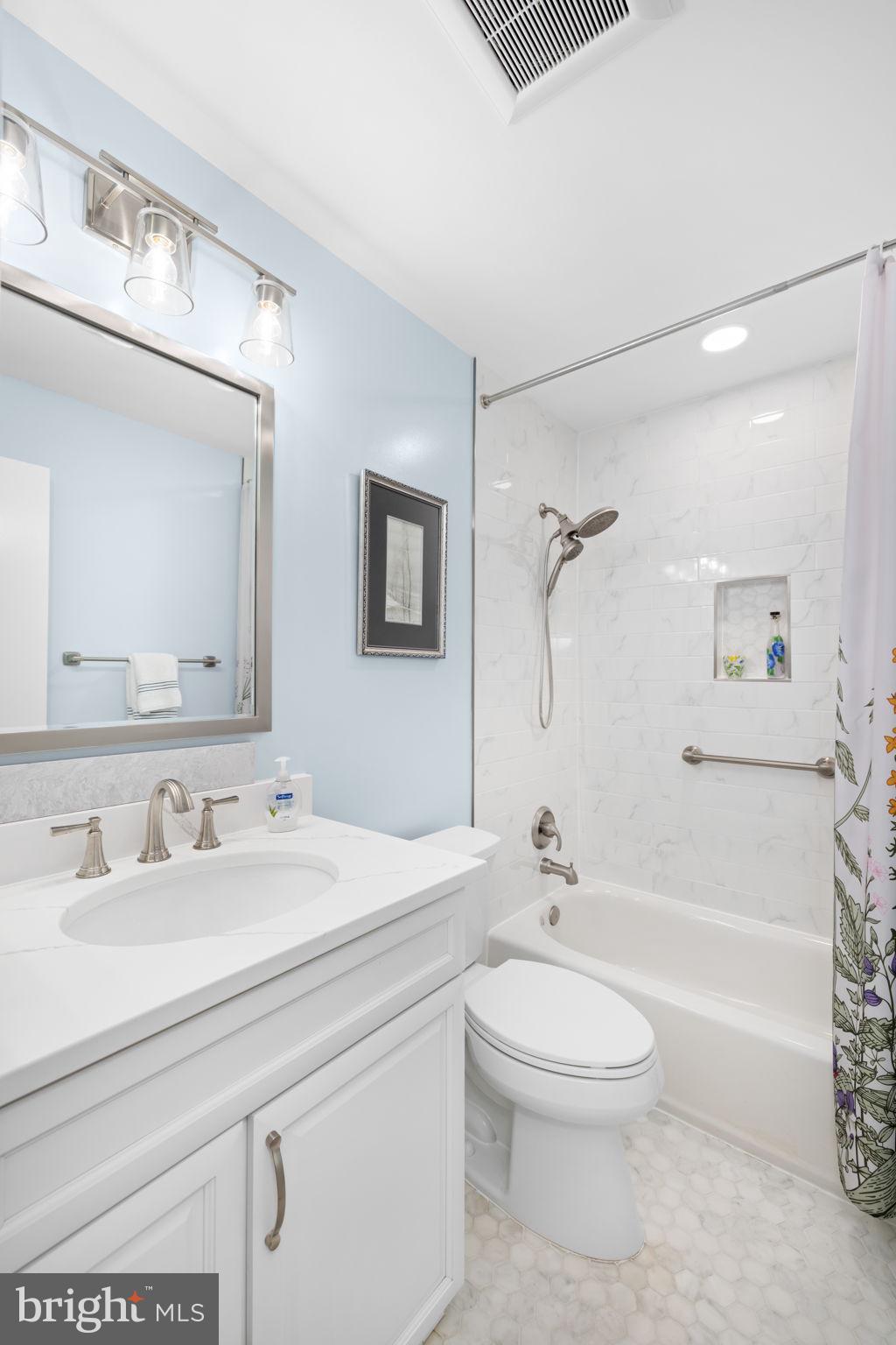 6964 Conservation Drive Springfield, VA 22153 - Photo 28 of 57 a bathroom with a toilet a sink a mirror and a bathtub