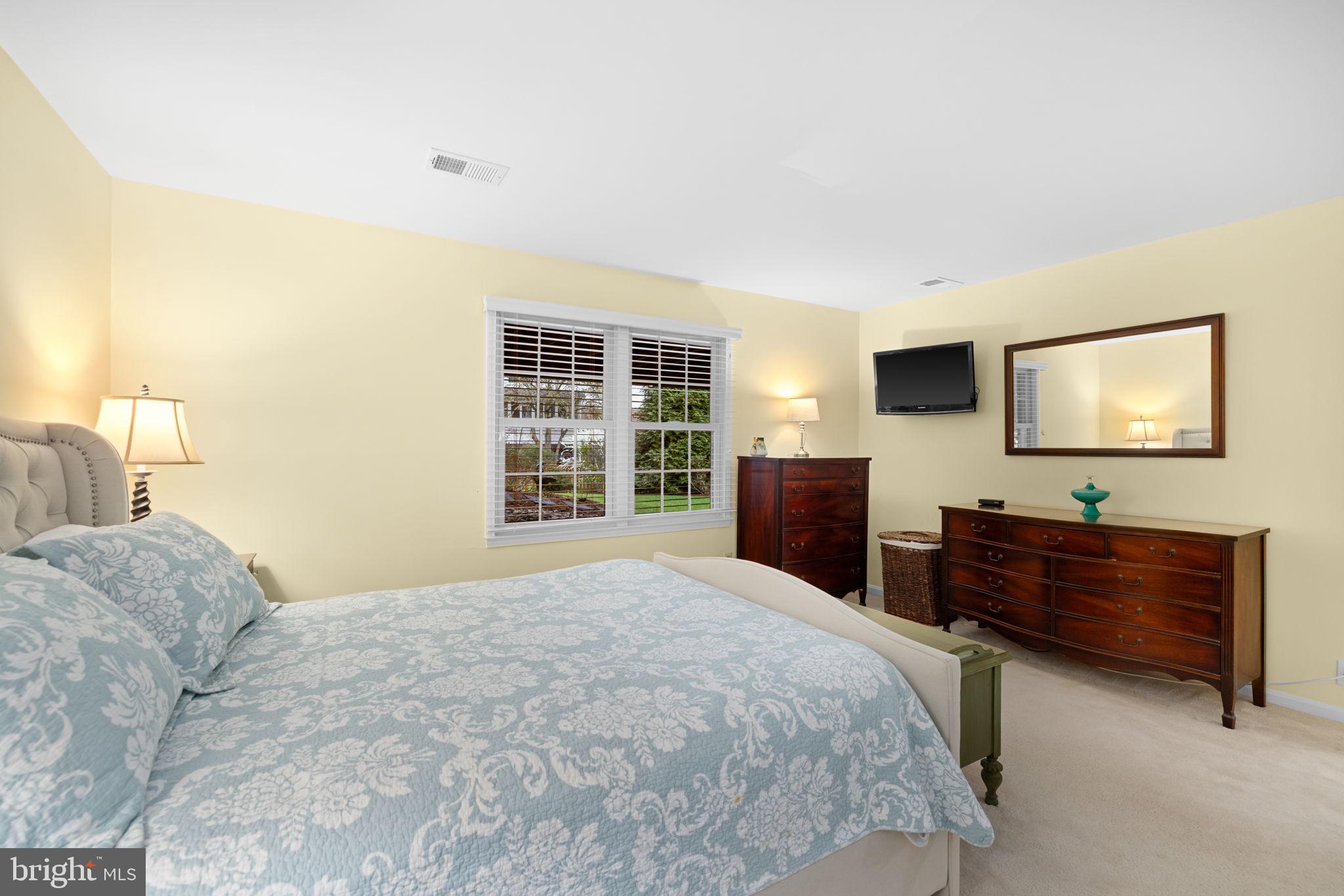 6964 Conservation Drive Springfield, VA 22153 - Photo 38 of 57 a bedroom with a bed and a flat screen tv