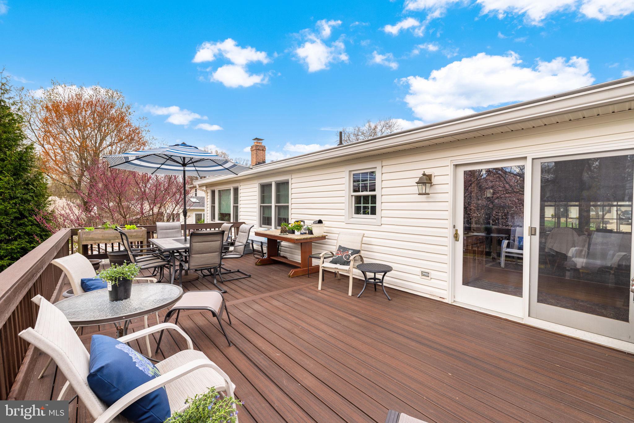 6964 Conservation Drive Springfield, VA 22153 - Photo 55 of 57 a view of a patio with dining table and chairs with wooden floor