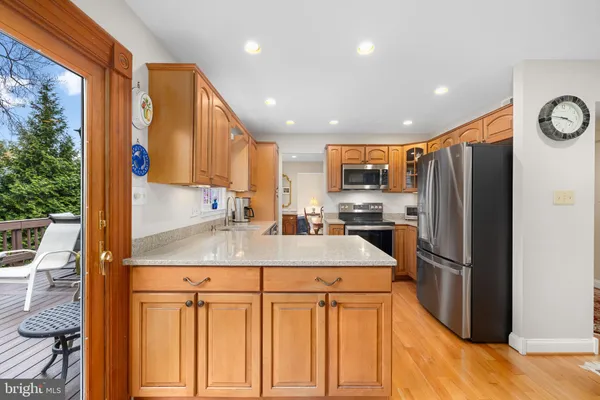 a kitchen with stainless steel appliances granite countertop a sink and cabinets
