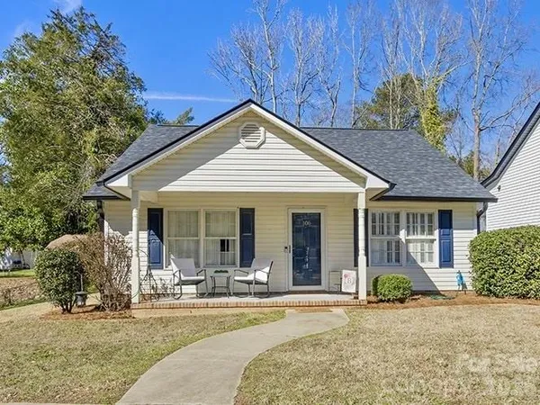 a view of a house with backyard porch and sitting area