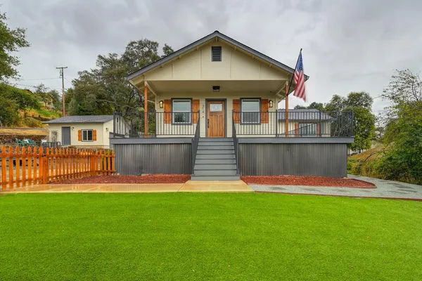 a front view of house with yard and green space