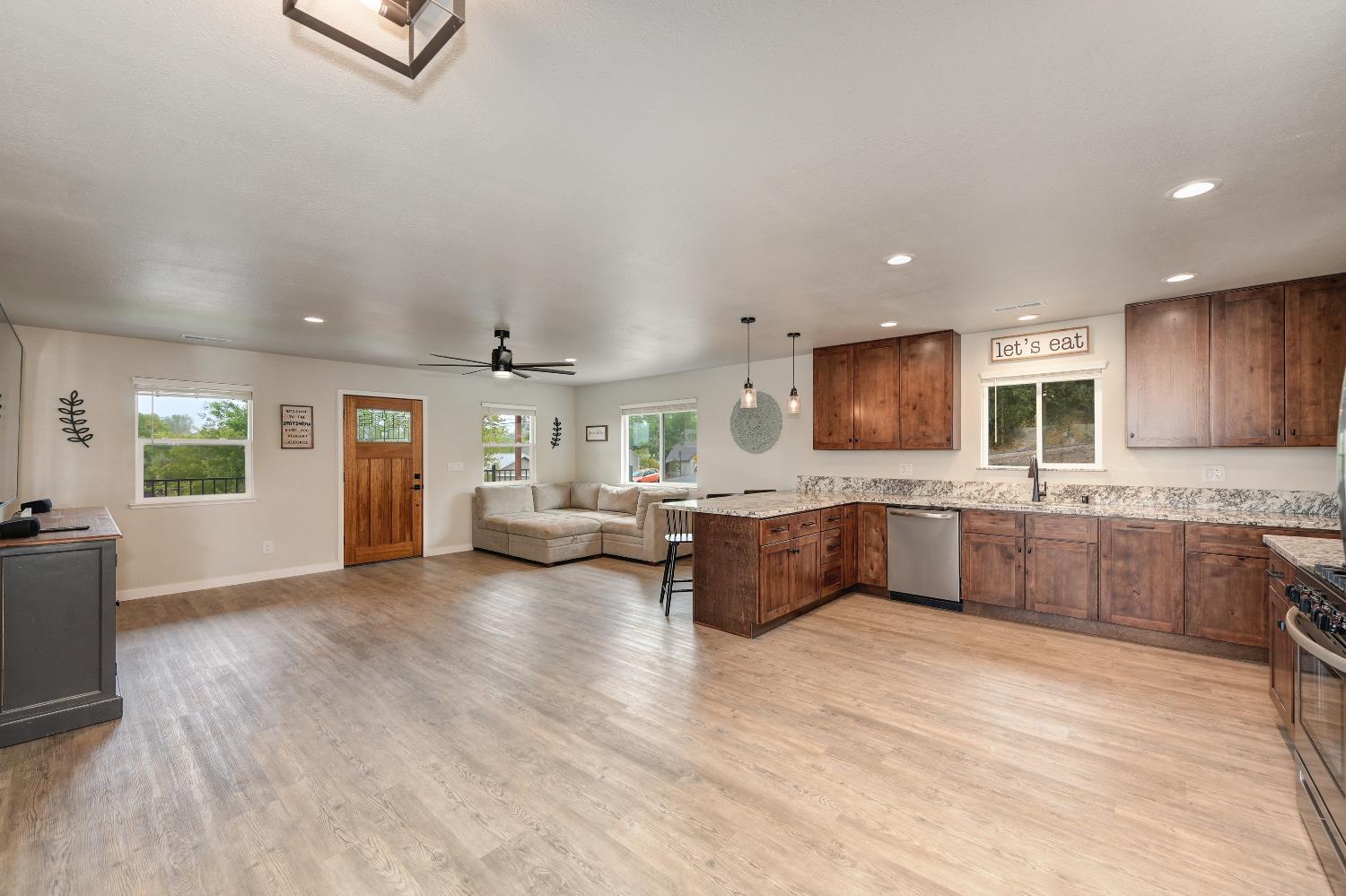 314 East Main Street Ione, CA 95640 - Photo 21 of 43 a large living room with stainless steel appliances kitchen island granite countertop a large kitchen island a stove a sink a refrigerator and a cabinets