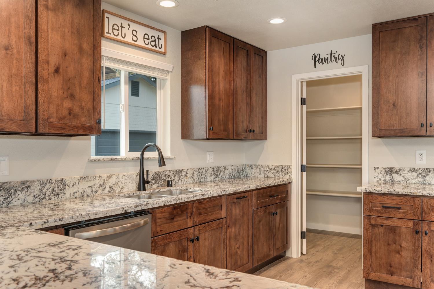 314 East Main Street Ione, CA 95640 - Photo 22 of 43 a kitchen with a sink cabinets and wooden floor