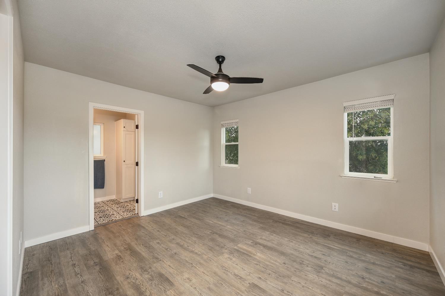 314 East Main Street Ione, CA 95640 - Photo 24 of 43 wooden floor in an empty room with a window