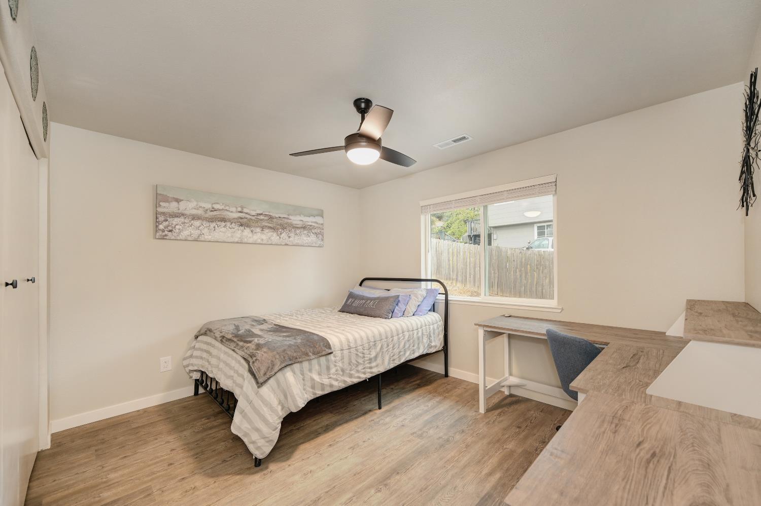 314 East Main Street Ione, CA 95640 - Photo 28 of 43 a bedroom with a bed and a chandelier