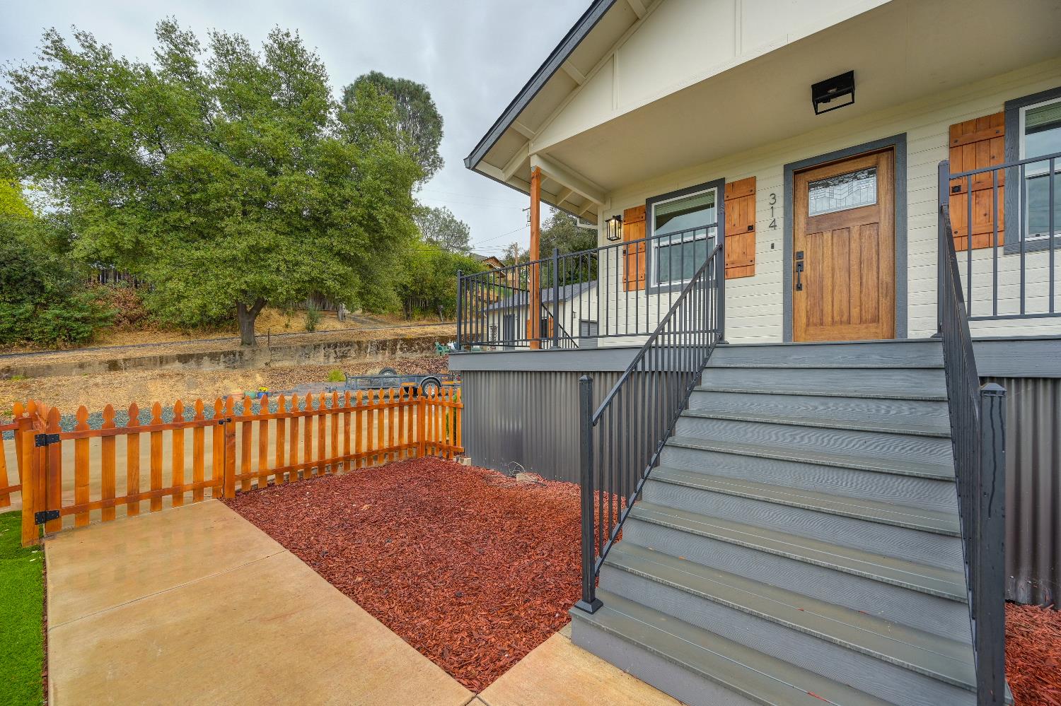314 East Main Street Ione, CA 95640 - Photo 8 of 43 a view of a balcony with wooden floor and fence