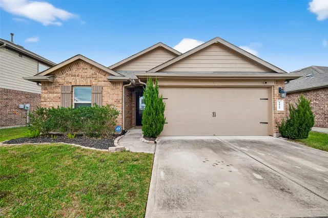 a view of a house with a yard and garage