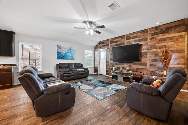 a living room with furniture and a flat screen tv