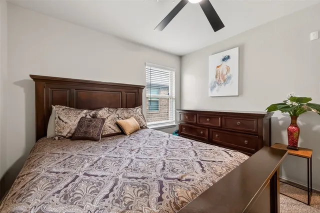 a bed room with a bed and a dresser