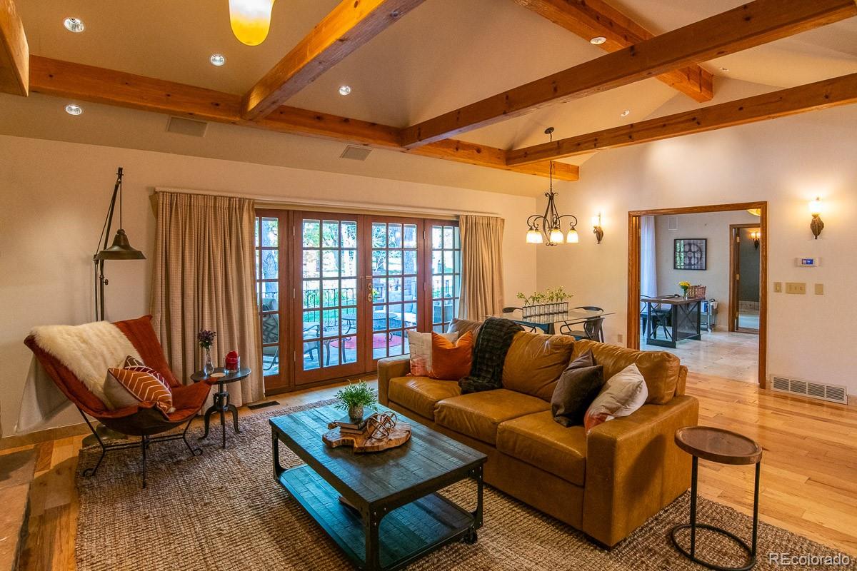 7181 Four Rivers Road Boulder, CO 80301 - Photo 11 of 35 a living room with furniture a rug and a chandelier