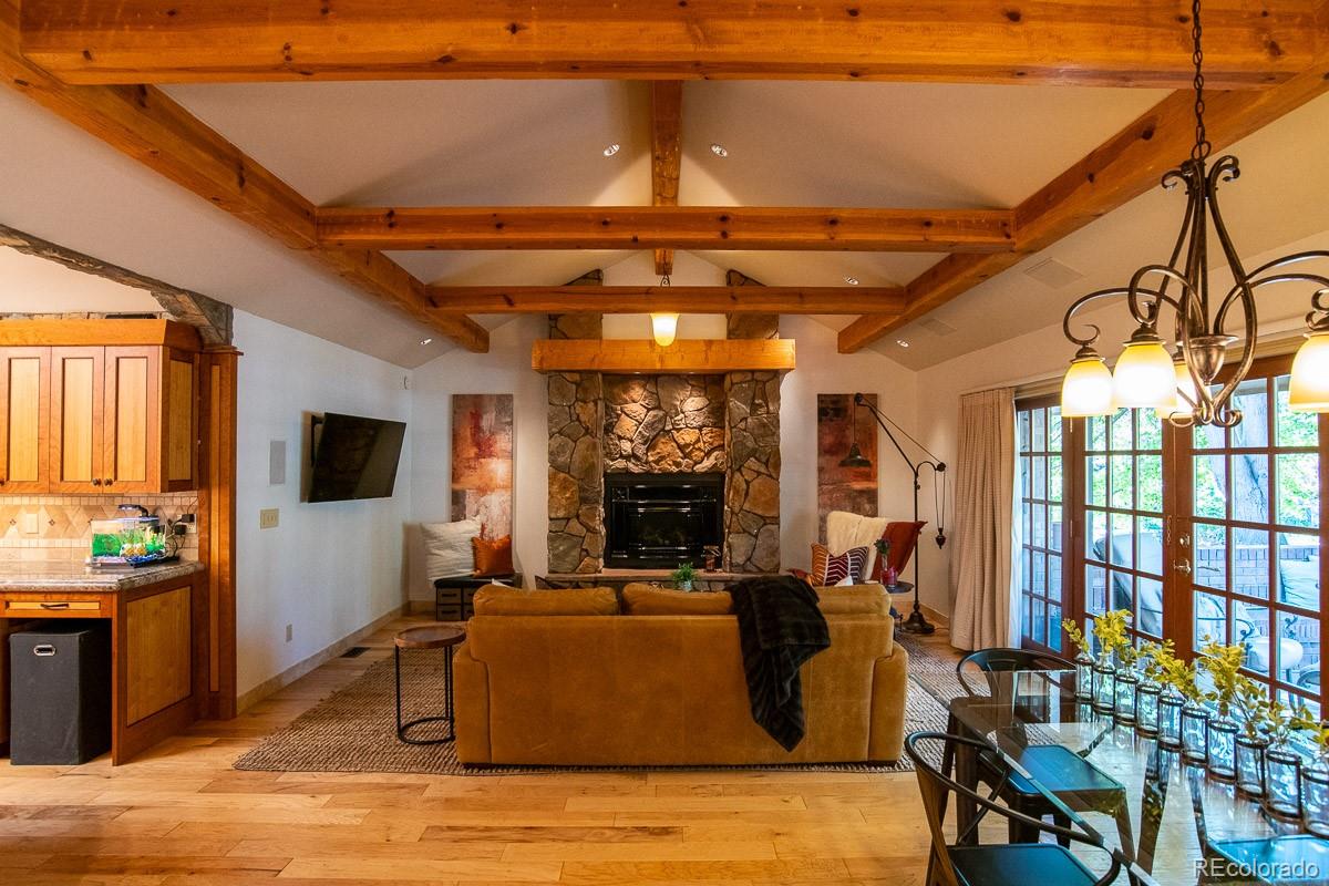 7181 Four Rivers Road Boulder, CO 80301 - Photo 13 of 35 a living room with fireplace furniture and a flat screen tv