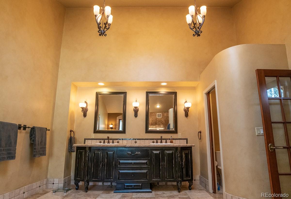 7181 Four Rivers Road Boulder, CO 80301 - Photo 18 of 35 a bathroom with a double vanity sink and a mirror