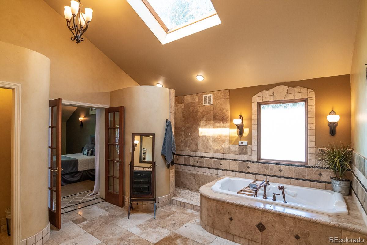 7181 Four Rivers Road Boulder, CO 80301 - Photo 19 of 35 a bathroom with a tub sink and mirror